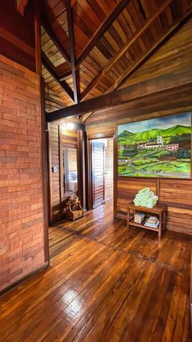 a living room with a large painting on the wall at Los de Arriba Hotel Cabaña familiar con piscina en Calima in Darién