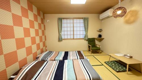 Ένα ή περισσότερα κρεβάτια σε δωμάτιο στο Garden House Umenoya Otaru