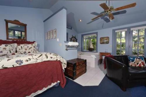 a bedroom with a bed and a ceiling fan at Country Cottage of Langley in Langley