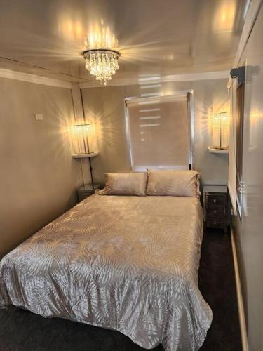 a bedroom with a bed and a chandelier at Our Casetta in Richmond
