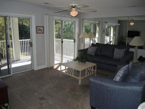 a living room with a couch and a table at Brunswick Plantation Villa 1005 in Calabash