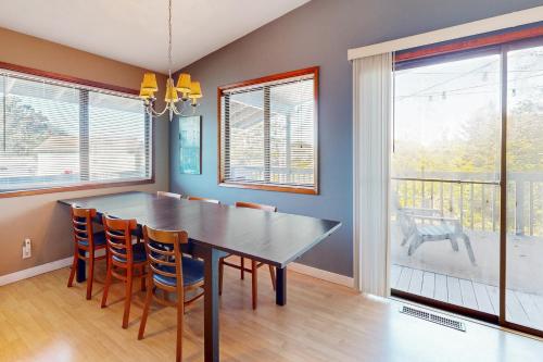 a dining room with a black table and chairs at Evergreen in Depoe Bay