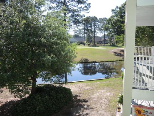 a view of a pond next to a house at Brunswick Plantation Villa 1005 in Calabash