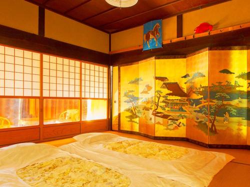 a bedroom with a large bed with a painting on the wall at Kyoto - House / Vacation STAY 14527 in Kyoto