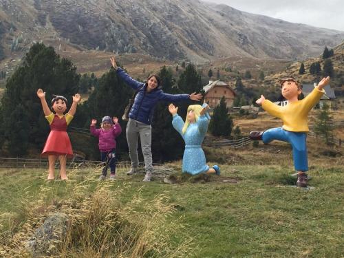 a group of people standing on a hill with their arms in the air at House Arianna in Bad Kleinkirchheim