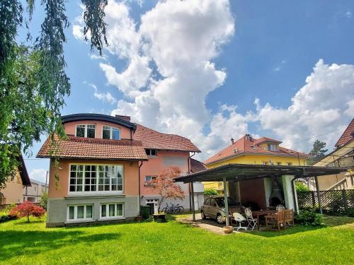 a house with a car parked in the yard at R24, ROSE house in Ljubljana