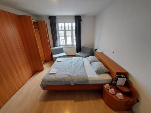 a small bedroom with a bed and a window at R24, ROSE house in Ljubljana