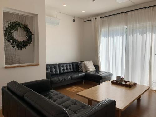 a living room with a couch and a table at 함덕리준하네 in Jeju