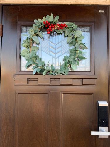 a door with a christmas wreath on it at 함덕리준하네 in Jeju