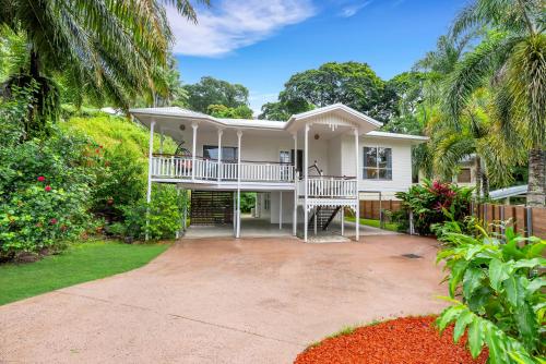 a white house with a porch and a driveway at 'Tropical Refuge' Classic Queenslander Paradise in Stratford