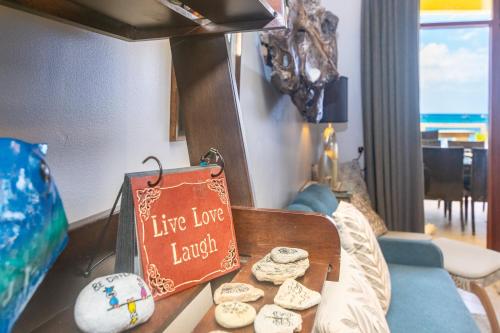 a table with cookies and a sign in a living room at Del Playa #1 Condo in West End