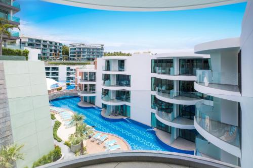 an aerial view of a building with a swimming pool at Lets Phuket Twin Sands Resort & Spa in Patong Beach