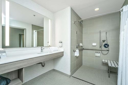 a bathroom with a sink and a shower at Holiday Inn Express & Suites Charleston Arpt-Conv Ctr Area by IHG in Charleston