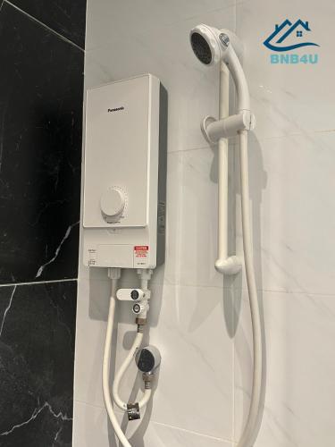 a soap dispenser on a wall in a bathroom at Beacon Executive Suites - By IZ in George Town