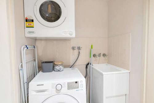 a laundry room with a washing machine and a washer at 'Poolside at Whitfield Waters' Resort-style Retreat in Edge Hill