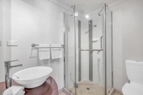a bathroom with a shower and a white toilet at Whitfield Waters - Resort Living for Families in Edge Hill