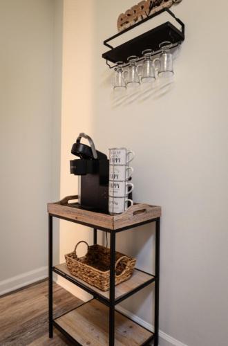 a shelf with a coffee maker and a basket on it at Quaint and quiet Columbus Ga stay in Columbus