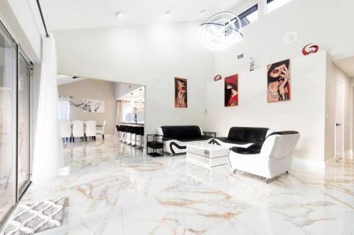 a living room with white furniture and a marble floor at Modern Lakefront Home in Wellington