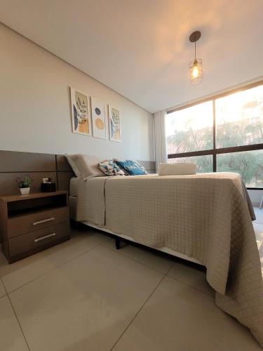 a bedroom with a large bed and a window at Cozy Studio in Intermares in Ilha da Restinga