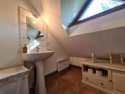 a bathroom with a sink and a skylight at Ancien moulin avec piscine, terrasse, jardin privatif et petite île - près des étangs de la Brenne - FR-1-591-159 in Prissac