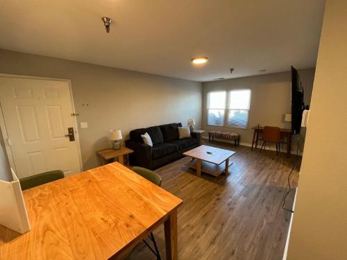 a living room with a couch and a table at Aksarben 1 Bedroom-Close to I-80 in Omaha