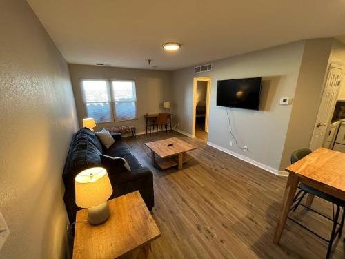 a living room with a couch and a table at Aksarben 1 Bedroom-Close to I-80 in Omaha