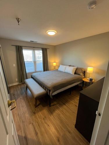 a bedroom with a large bed and a window at Aksarben 1 Bedroom-Close to I-80 in Omaha