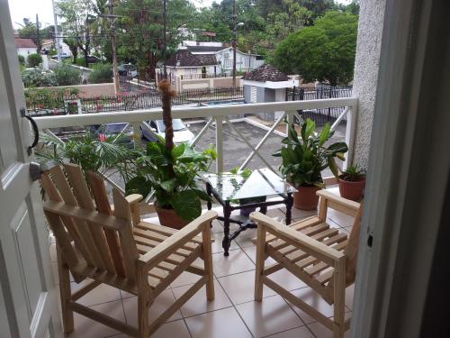 two chairs and a table on a balcony with plants at Cozy Waterloo Apartment in Kingston