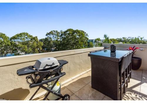 a bicycle with a helmet sitting on a balcony at Noosa Riverside Getaway in Noosa Heads
