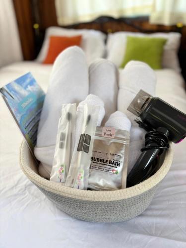 a basket of towels and other items on a bed at DeeTorJai FarmStay Nan ดีต่อใจ ฟาร์มสเตย์ น่าน โดยเจ้าของ in Ban Klang