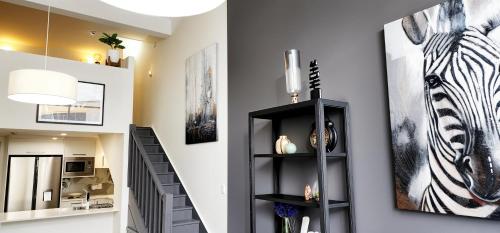 a living room with a zebra picture on the wall at NYC Loft Brisbane, Free Parking! in Brisbane