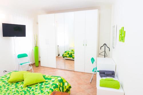 a bedroom with a bed and a mirror at B&B Arcobaleno Affittacamere Rainbow in Alessandria