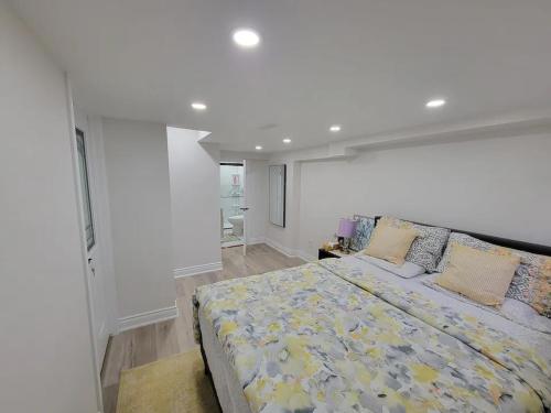 a large white bedroom with a large bed in it at One Bedroom Apartment in Ajax