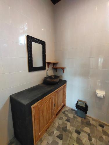 a bathroom with a sink and a mirror at Molog guest house in Ubud