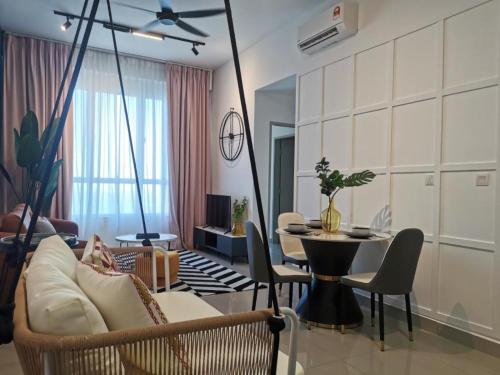 a living room with a swing couch and a table at Amber Cove - Luxury Design By Luxpro Management - 6~7 pax in Malacca