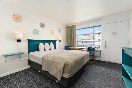 a hotel room with a bed and a window at Eden Roc Motel in Ocean City