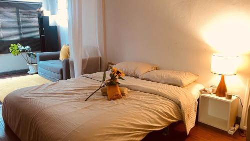 a bedroom with a bed with a flower on it at MIDNIGHT CREPES Homecafe/Lifestyle Studio in Ban Bang Toei (1)