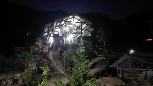 a large building with lights on it at night at Miss Ann Homestay in Sa Pả
