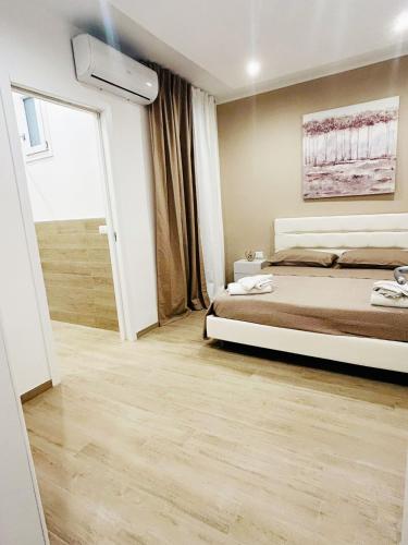 a bedroom with a bed and a large window at BED e SUITE DOMAR in Brindisi