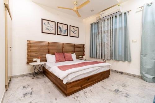 a bedroom with a large bed and a window at Stylish & Cozy Retreat with Jacuzzi in Jaipur