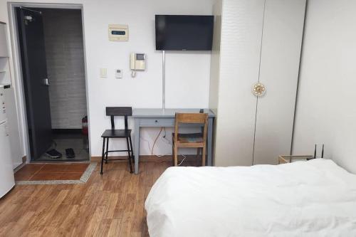 a bedroom with a bed and a desk and a table at Kiman09 in Seoul