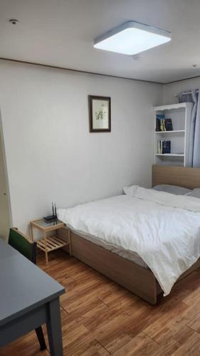 a bedroom with a bed and a table in it at Kiman09 in Seoul