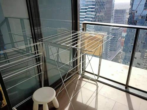 a chair sitting in front of a window at L39 1Min to SouthernCross,free Gym, Pool, sunna,Tram ,Sauna in Melbourne