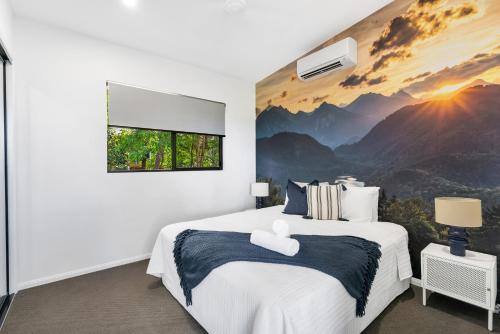 a bedroom with a mountain mural on the wall at Ohana - The Ultimate Family Pool Escape in Kewarra Beach