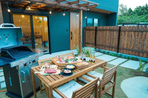 a patio with a table with a grill and a stove at TAITO BEACH HOUSE in Ichigaya