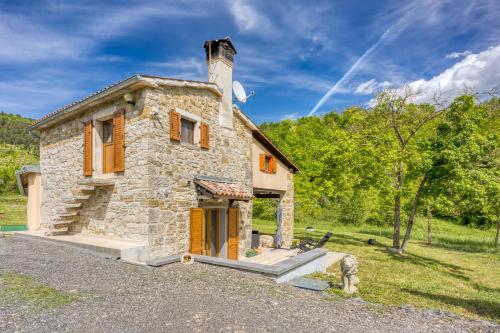 a stone house in a field with trees at Casa La Vida - Happy Rentals in Livade