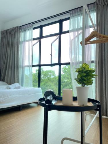a bedroom with a table and a bed and a window at 1min to BukitIndah AEON Skyloft 3BR Muji PoolView in Johor Bahru