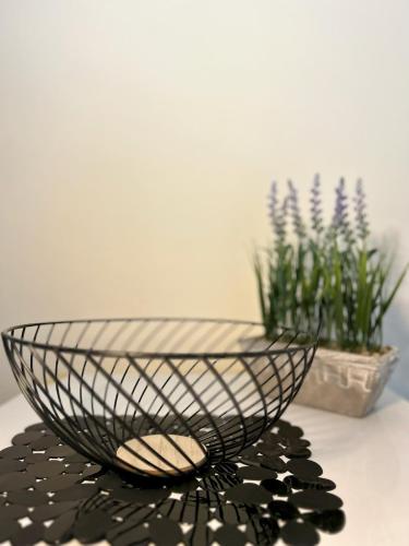 a black bowl sitting on a table with flowers at Hermanos in Flogita