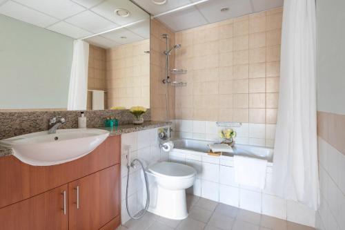 a bathroom with a sink and a toilet and a shower at Frank Porter - Al Dhafrah 2 in Dubai