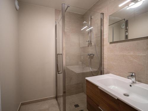 a bathroom with a shower and a sink and a mirror at Chalet Valmorel, 4 pièces, 6 personnes - FR-1-356-392 in Valmorel